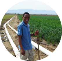 Romulus Okwany, Ph.D student setting up a surge irrigation system
